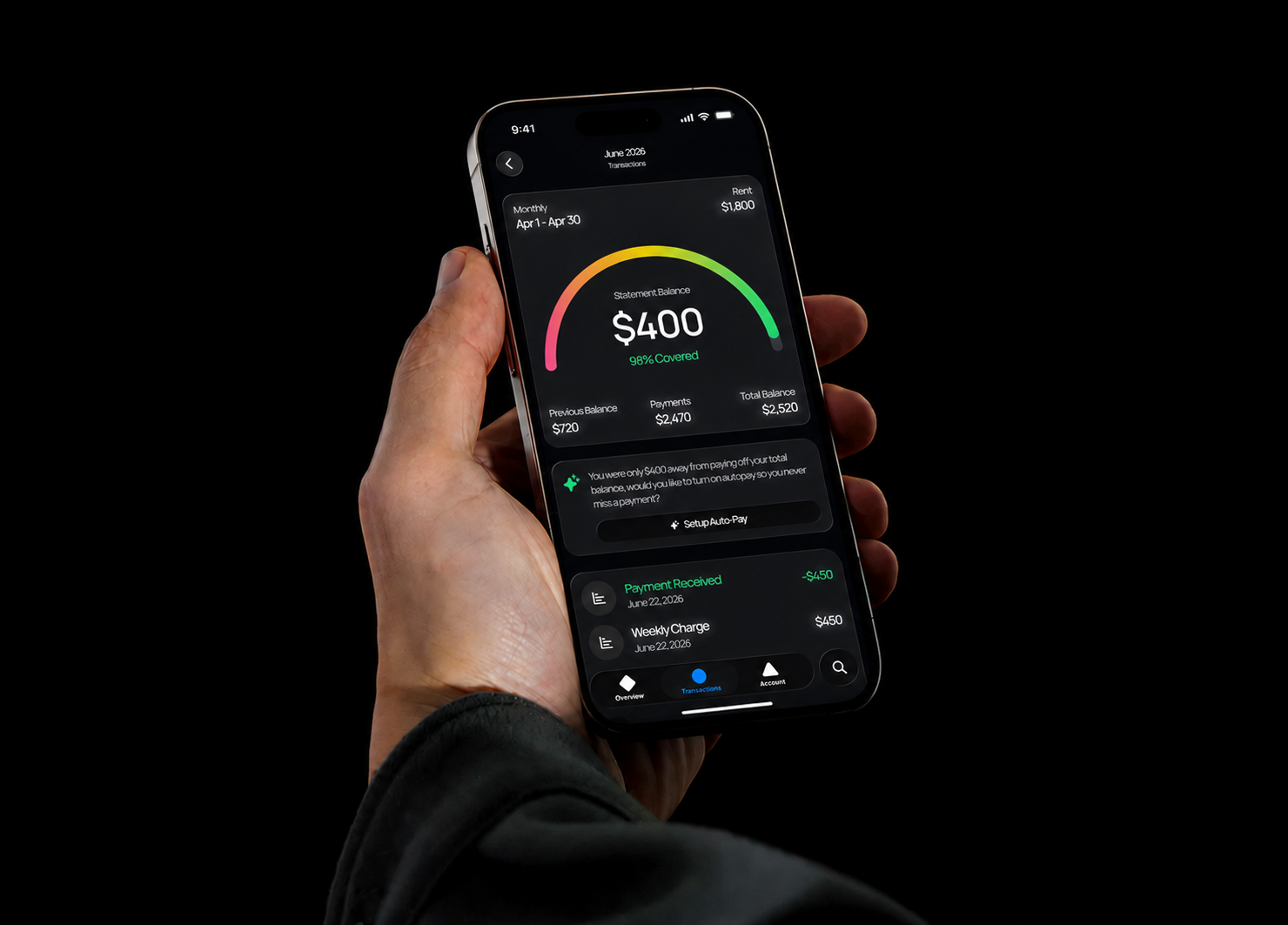 A hand holding a phone showing a Spread rent balance and payments screen.