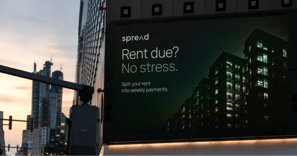 Large city billboard reading Rent due? No stress.